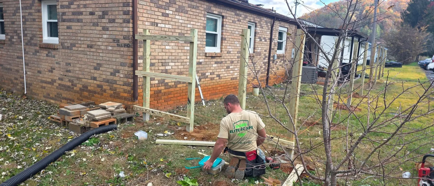 Pressure-treated posts and rails during construction of the privacy fence